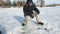 Fisherman drills hole in ice close up view, sport fishing in winter.