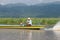 Fisherman driving in wooden boat on inle lake in myanmar asia