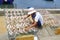 Fisherman drying fish in sunlight