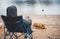 Fisherman enjoy hobby fishing rod with pet on lake, person catch fish, holiday relax