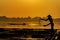 Fisherman feeds the fish in a commercial farm in Mekong river. Farmers feeding fish in cages, Mekong River. The Tilapia for