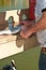 Fisherman filleting mullet fish at tropical marina