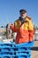 A fisherman with a fish box inside a fishing boat