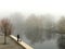 Fisherman fishing on a cold misty winter day