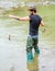 Fisherman with fishing rod. mature man fly fishing. man catching fish. bearded fisher in water. summer weekend. Big game