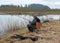 Fisherman fishing on the shore of the lake, amateur carp fishing, fishing as a hobby, early spring