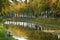 Fisherman is fishing on waterfront in autumn landscape