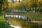 Fisherman is fishing on waterfront in autumn landscape