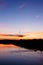 A fisherman floating on the river in the evening