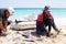 A fisherman guts a freshly caught fish on a Cuban beach 04 28 2022