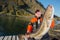 Fisherman happy man holding a huge fish Cod. Pier. horizontal po