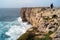 Fisherman with his gear on the edge of the cliff, Sagres, Algarve, Portugal