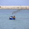 Fisherman with his old diesel powered boat with steaming muffler in the sea