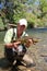 Fisherman holding big brown trout in the river