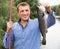 Fisherman holding catch fish in hands outdoors