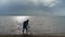 Fisherman holding fishing net in the beach 4k