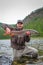 A fisherman holding a taimen trout caught on a river in Mongolia, Moron, Mongolia