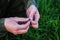 Fisherman holds a hook and worm rain