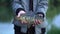 fisherman holds a mirror carp in his hands.