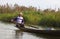 Fisherman on Inle lake rowing his canoe on the wat