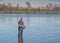 Fisherman in the lake. Ecotourism, visiting fragile, pristine, undisturbed natural areas Active fishing holidays