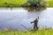 Fisherman lure fish in the river for fishing with a float rod