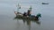 Fisherman maintenance and repair wooden fishing boat ship floating in sea ocean