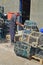 Fisherman mending his pots in Newlyn Harbour, Cornwall UK