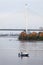 Fisherman on motor boat near the Big Obukhovsky cable-braced bridge, St. Petersburg, Russia