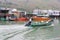 Fisherman is navigating in the fishing village Tai O at Lantau Island with houses on stilts, Hongkong