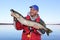 Fisherman Poses with Northern Pike Fish