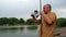 Fisherman pulls the fish out of the river with carp fishing equipment. Angler with carpfishing rod in cloudy summer day