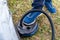 A fisherman pumps an inflatable boat with a foot pump. Inflatable boat pumping process, close-up