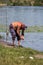 Fisherman puts on the signal bell on the line feeder