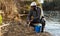 Fisherman putting fish in bucket