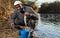 Fisherman putting fish in bucket