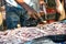 Fisherman putting fresh fish on bag selling at the local fish market in Galle, Sri Lanka