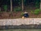 Fisherman on reinforced shoreline along Li River, Guilin, China