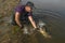 Fisherman release zander fish with splashing. Success walleye fishing at wild river