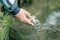 Fisherman releases the fish caught in the lake or river