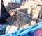 Fisherman repairing a fishnet in his boat