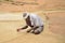 Fisherman repairs a fishing net