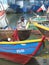 A fisherman repairs fishing network