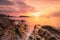 Fisherman on rock in Kalim beach at sunset, Phuket