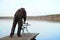 Fisherman with rod pod, feeders, electronic bite alarms on pier