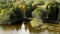 Fisherman on a rubber boat on a lake, autumn landscape