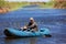 Fisherman in rubber boat on the river