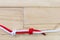 Fisherman\'s knot made with red rope on wooden background.