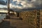 Fisherman`s pier on the bay at sunset. Lobster traps on a wooden pier and boats on the water.