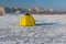Fisherman`s tent located on a frozen Dnepr river in center of the same city, Ukraine